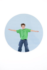 Young boy standing with arms out smiling