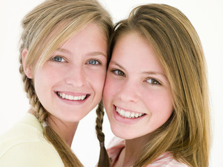 Two girl friends together smiling