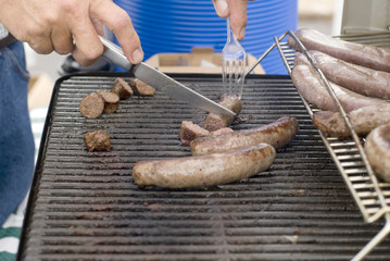 Italian sausages being grilled at a summer barbeque.