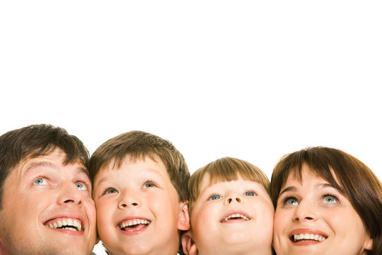 Photo of happy family looking upwards on white background