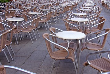 Terrace with brown chairs and round tables