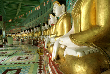 Buddhgas in golden robas on Sagaing Hill, Mandalay, Myanmar