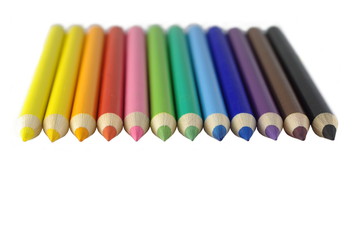 different colourful sharpened crayons on white background
