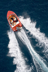 family into fast driving boat on the sea