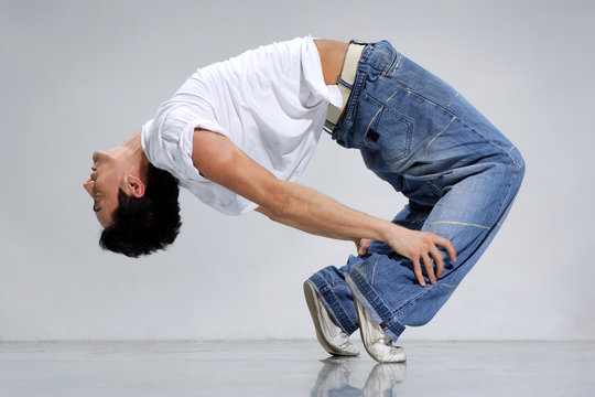 breakdancer posing on a grey background
