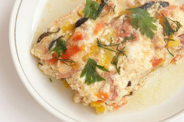 Omelette with a ham, vegetables in a white plate