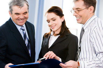 Business group of three people discussing plan at meeting