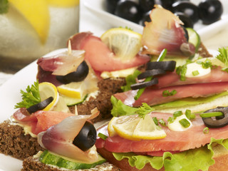 delicious canapes with smoked salmon, olive and cucumber
