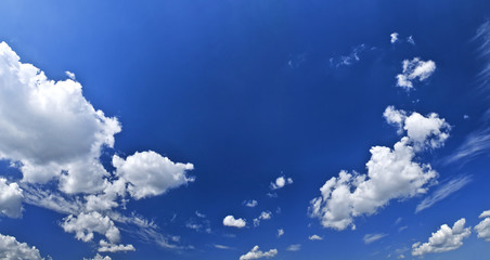 Panoramic background of blue sky with white cumulus clouds