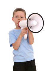 6-7 years old boy sitting with megaphone isolated on white