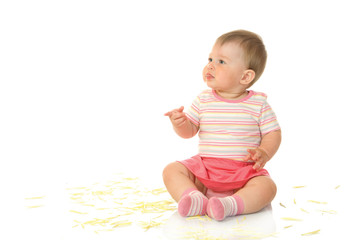 Fototapeta premium Sitting small baby with yellow petals isolated