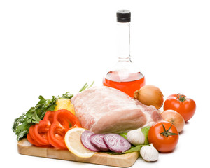 Fresh meat with vegetables on a white background. Close up.