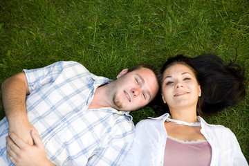 happy couple lying on grass