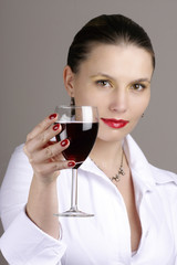 Portrait of beautiful woman with glass red wine