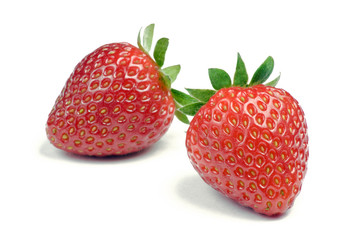 Two ripe strawberries on white background