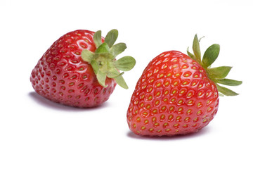 Two ripe strawberries on white background