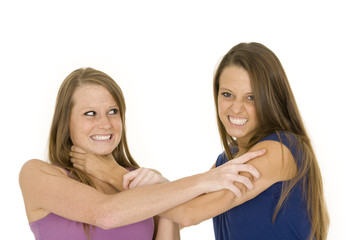 Two caucasian woman fighting on white background