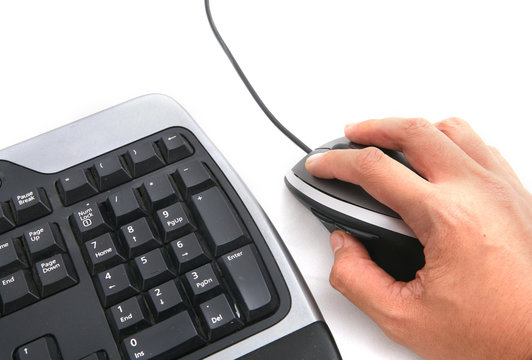 Isolated Ergonomic Keyboard And Hand On Mouse