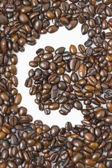 Shot of coffee beans framing letter C
