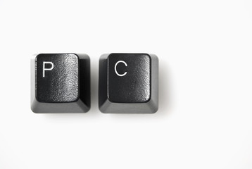 Computer keys spelling PC, shot against white