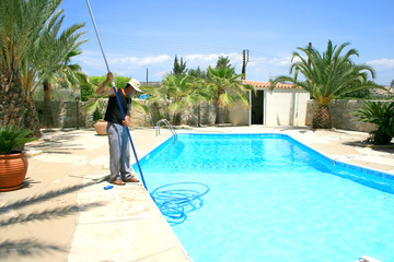 Swimming pool cleaner during his work.