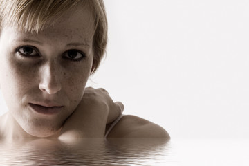 Studio portrait of a blond short haired girl looking sad