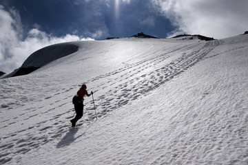 Girl clambering to top in snow