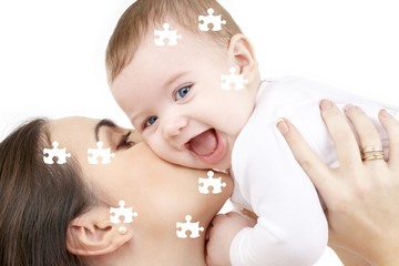 Obraz na płótnie Canvas puzzle picture of happy mother with baby over white