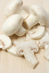 Fresh mashrooms sliced on wooden chopping board