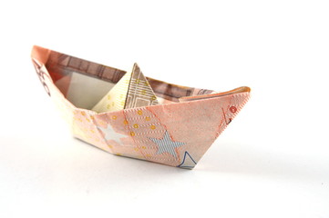 Obraz premium Ship made of money isolated on a white background.