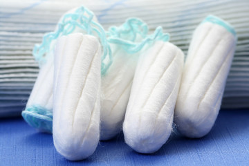 health care and medicine - white tampons on blue background