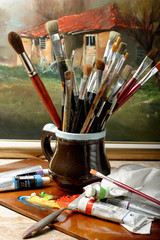 Art brushes well used in a jar on studio
