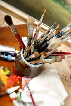 Art brushes well used in a jar on studio