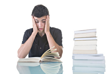 Stressed young student with a pile of books to read