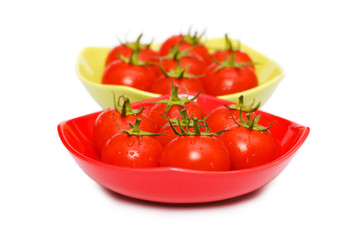 Wet whole tomatos isolated on white background
