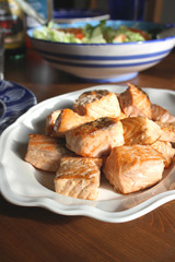 Salmon pieces on a white plate