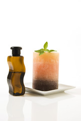 Still life of mineral oil, basil, and candle