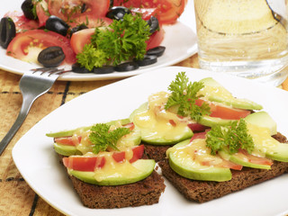 vegetarian diner - salad with tomatos and sandwich with cheese