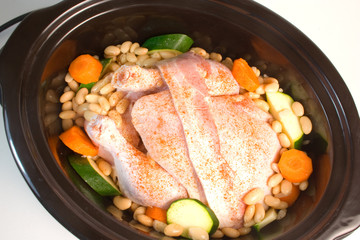 Fresh chicken prepared for cooking in a slow cooker.