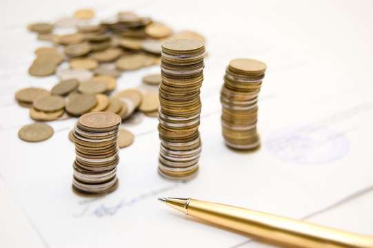 Coins on  written contract background