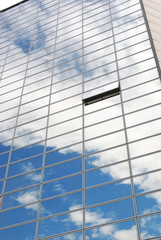 Modern office building with sky reflection in windows