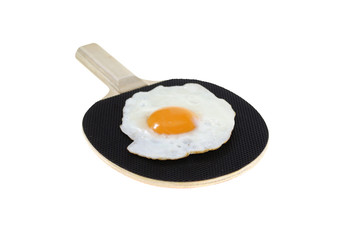 fried egg on black bat isolated on white background