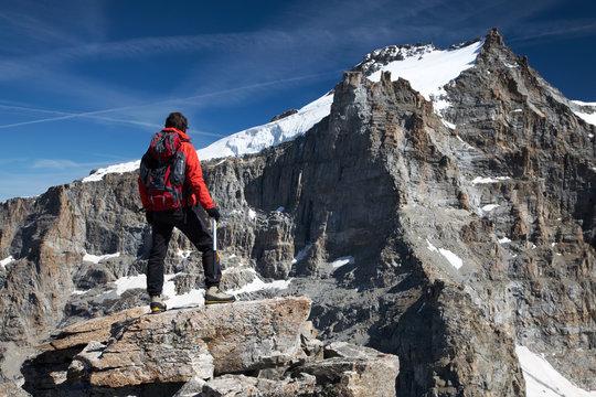 Hiker and landscape of Gran Paradiso peak (4046 mt), Italy