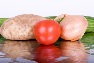 Fresh vegetables reflected on a piece of aluminum foil