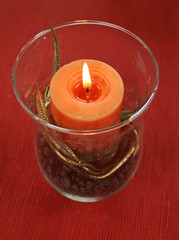 Decorative candle with gold leaf in a glass candle holder