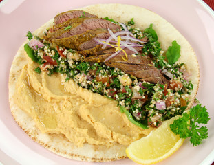 Middle Eastern lamb fillet on pita bread with hommus