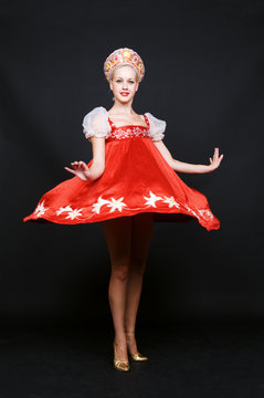 russian beauty spinning in dance over dark background