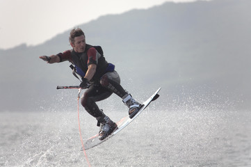 flying under water surface  wakeboarder in splash