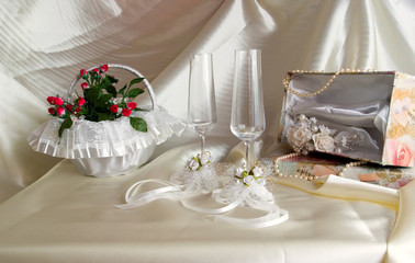 wedding still life is glasses and small basket with a bouquet