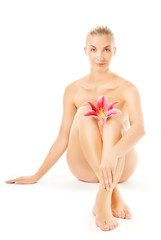 Obraz premium Beautiful young woman with pink lily flower